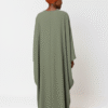 Women’s modest green abaya with flowing fabric and orange turban, perfect for stylish modest fashion.
