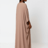 Nude-colored abaya featuring flowing silhouette, modest fashion, perfect for special occasions.