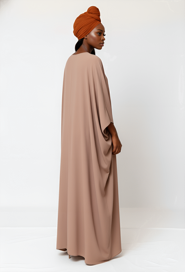 Nude-colored abaya featuring flowing silhouette, modest fashion, perfect for special occasions.