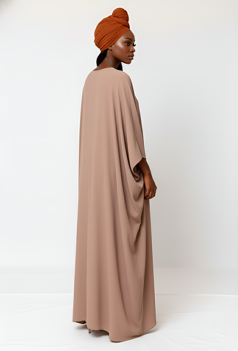 Nude-colored abaya featuring flowing silhouette, modest fashion, perfect for special occasions.