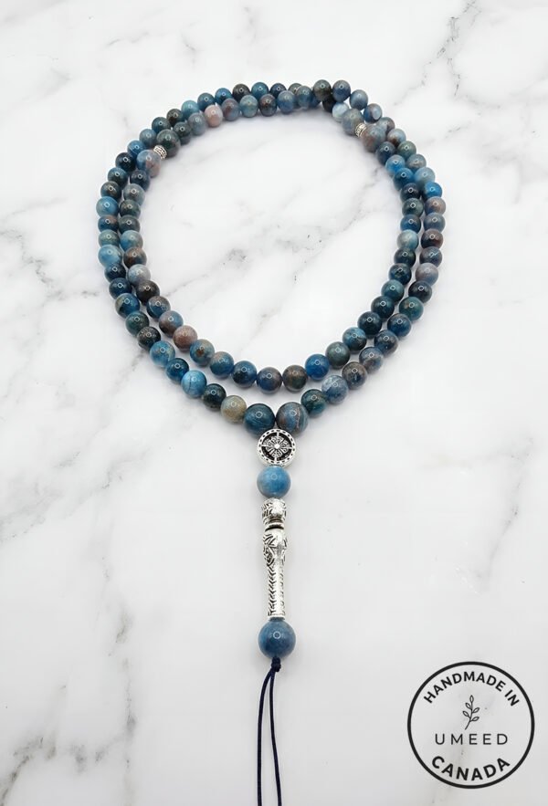 Blue gemstone beaded necklace with silver accents and a tassel, handmade jewelry from Umeed Designs.