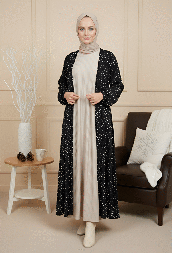 Stylish modest winter outfit featuring black polka dot coat and cream pleated dress for women.