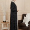Stylish black polka dot dress paired with beige hijab, perfect for modest fashion and special occasions.