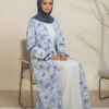 Beautiful woman wearing traditional blue and white embroidered abaya with a matching hijab for modest fashion.