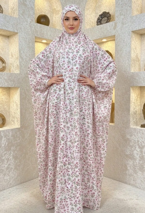 Elegant floral abaya with matching hijab for women, featuring a modest design and intricate pink and.