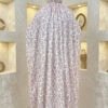 Fabric art installation with floral patterned cloth draped over a mannequin.
