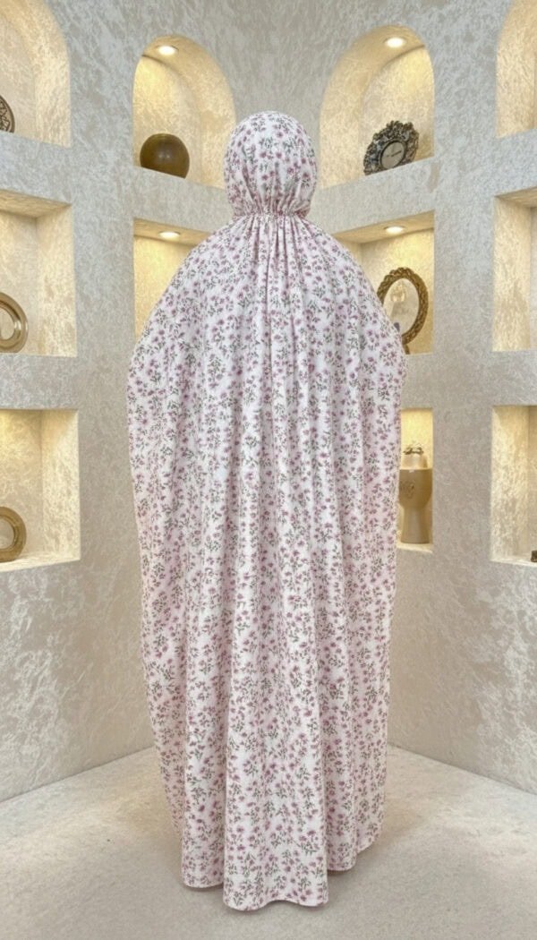 Fabric art installation with floral patterned cloth draped over a mannequin.