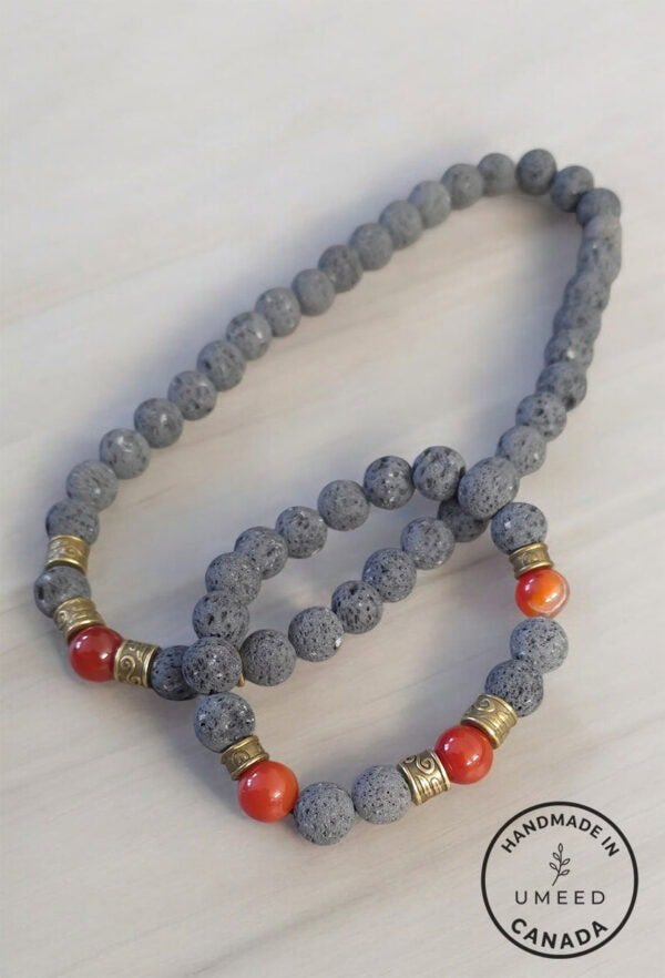 Handmade beaded necklace with grey and red stones, crafted in Canada.