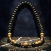 Elegant wooden beaded necklace with mixed natural tones and brass accents. Perfect for boho or casua.