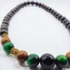 Handcrafted beaded jewelry with wooden and gemstone elements.