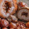 Geode with sparkling crystals and raw orange Carnelian stones.