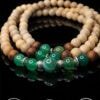Elegant beaded necklace with natural wood and green gemstone beads.