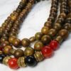 Elegant wooden beaded necklace featuring red and black beads with gold accents, handcrafted in Canad.