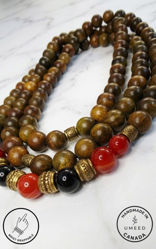 Elegant wooden beaded necklace featuring red and black beads with gold accents, handcrafted in Canad.