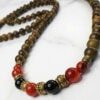 Elegant handmade wooden beaded necklace with red and black beads, crafted in Canada by Umeed Designs.