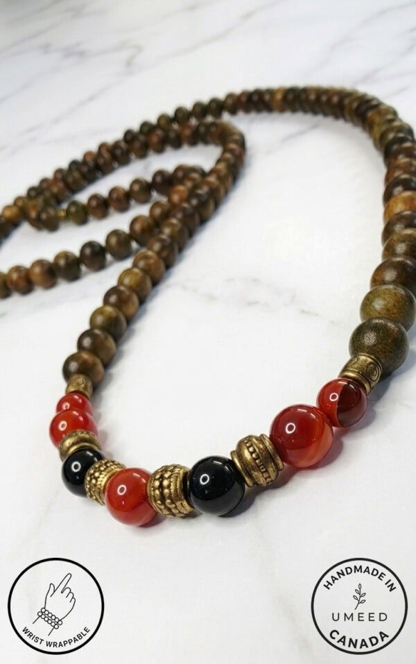 Elegant handmade wooden beaded necklace with red and black beads, crafted in Canada by Umeed Designs.