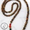 Handmade wooden and beaded necklace with red and black accents, crafted in Canada.