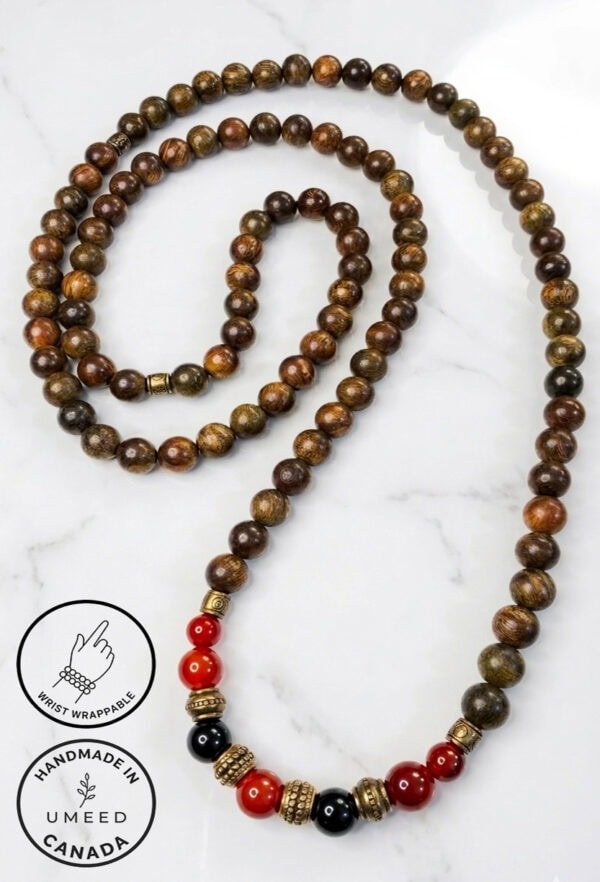 Handmade wooden and beaded necklace with red and black accents, crafted in Canada.