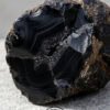 Black onyx geode crystal for jewelry making and healing practices. Unique natural stone with strikin.