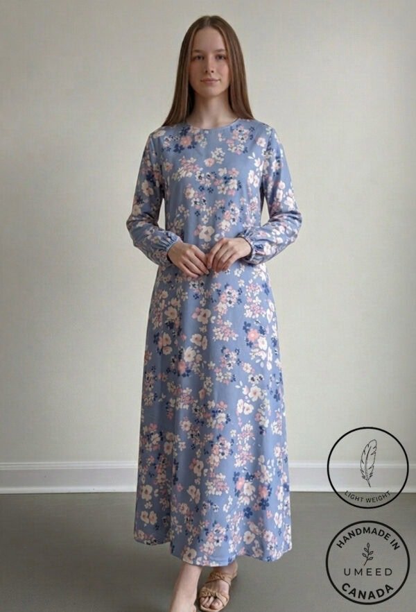 Elegant floral maxi dress in soft blue with pink and white flowers, perfect for casual or special oc.