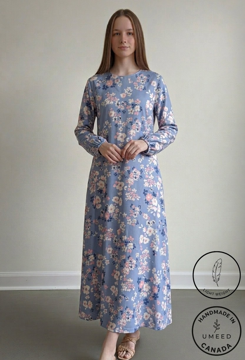 Elegant floral maxi dress in soft blue with pink and white flowers, perfect for casual or special oc.