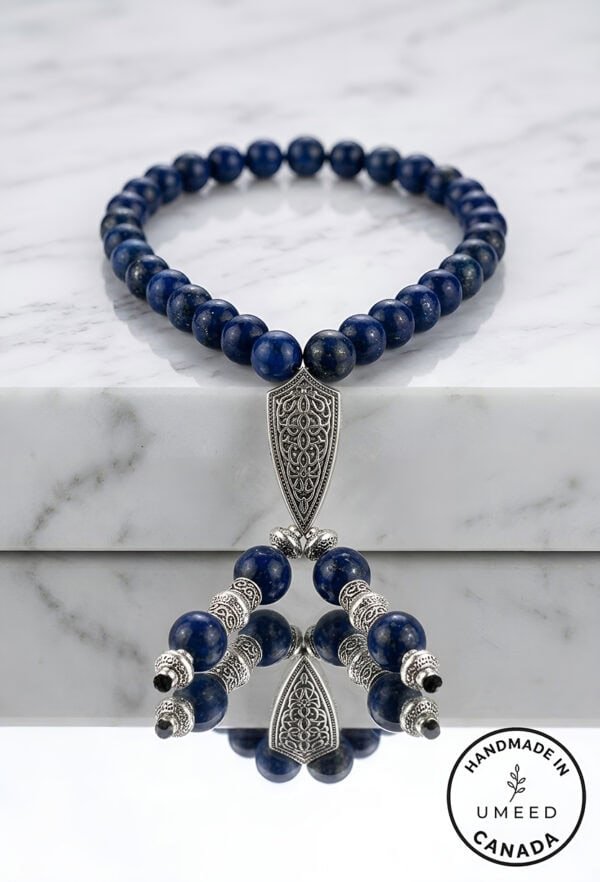 Handmade blue beaded necklace with intricate silver pendant, crafted by Umeed Designs in Canada.