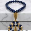 Elegant blue beaded necklace with gold accents and intricate pendant design.
