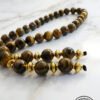 Elegant handcrafted tiger's eye beaded necklace with gold accents, made in Canada.