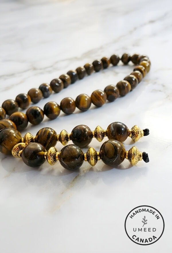 Elegant handcrafted tiger's eye beaded necklace with gold accents, made in Canada.