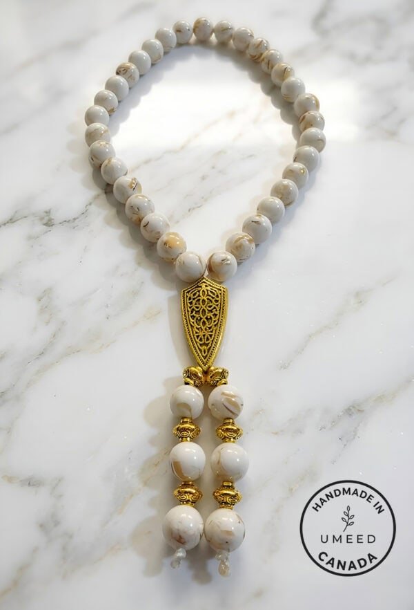 Elegant white and gold beaded necklace with intricate pendant, handmade in Umeed Designs, Canada.