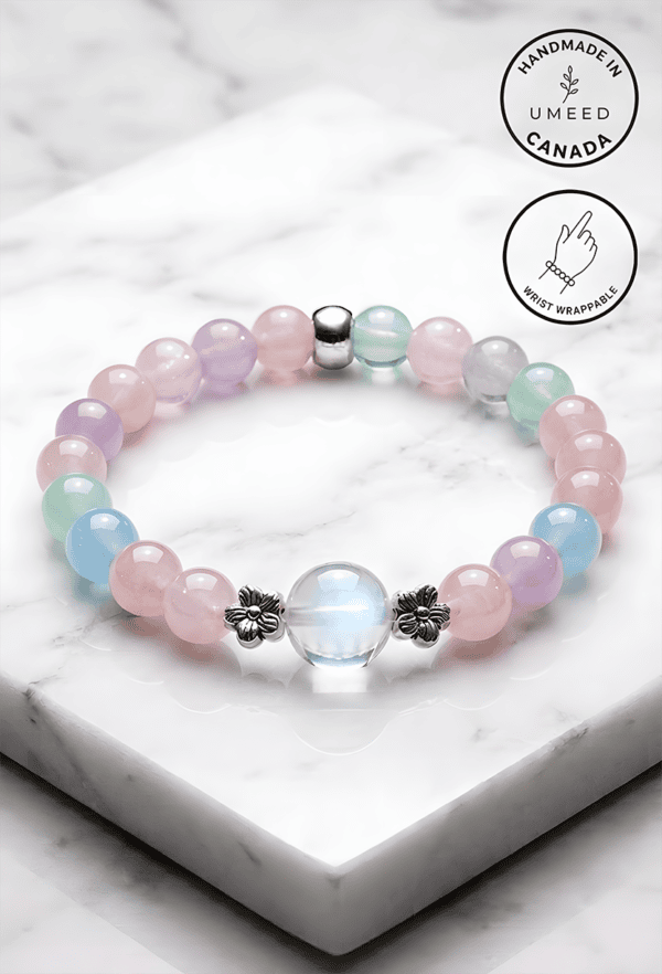 Elegant pastel beaded bracelet with silver accents, handmade in Canada, featuring a central glass be.