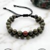 Handmade green and brown beaded bracelet with adjustable cord from Umeed Designs.