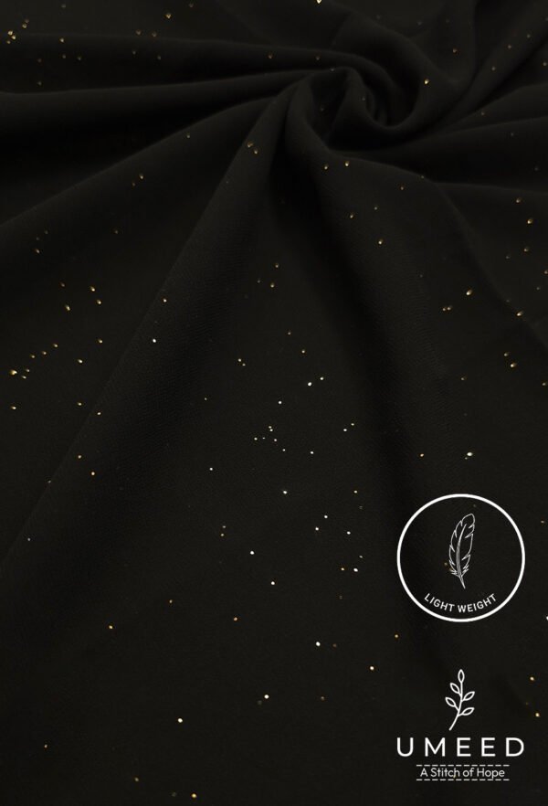 Black fabric with gold specks and light weight label from Umeed Designs.