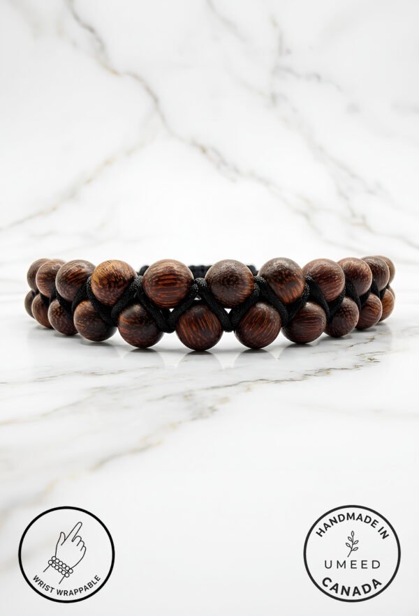 Handmade wooden bead bracelet from Umeed Designs on a marble surface.