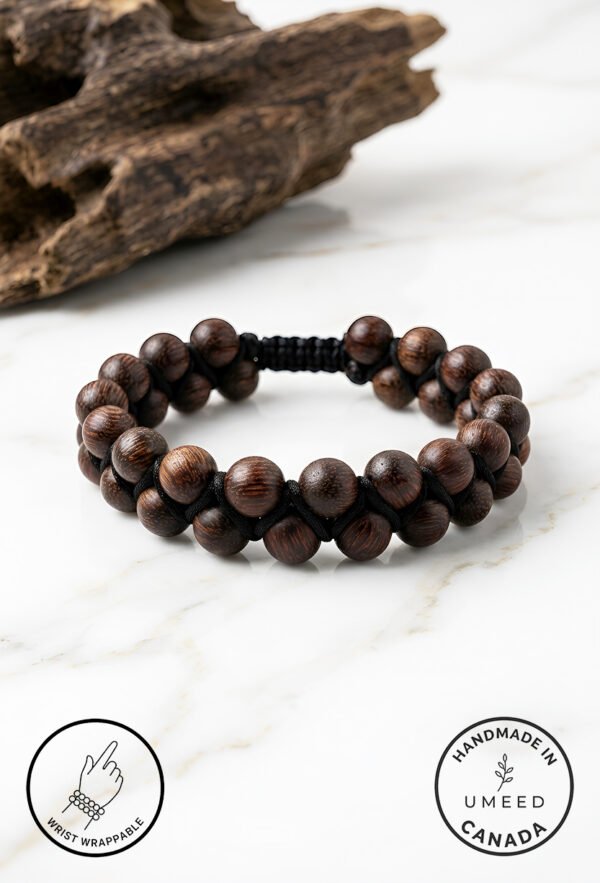 Handmade wooden bead bracelet from Umeed Designs on a marble surface.