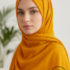Beautiful woman wearing a mustard yellow hijab with subtle polka dots.