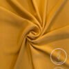 Lightweight, non-slip mustard yellow fabric for clothing or crafts.