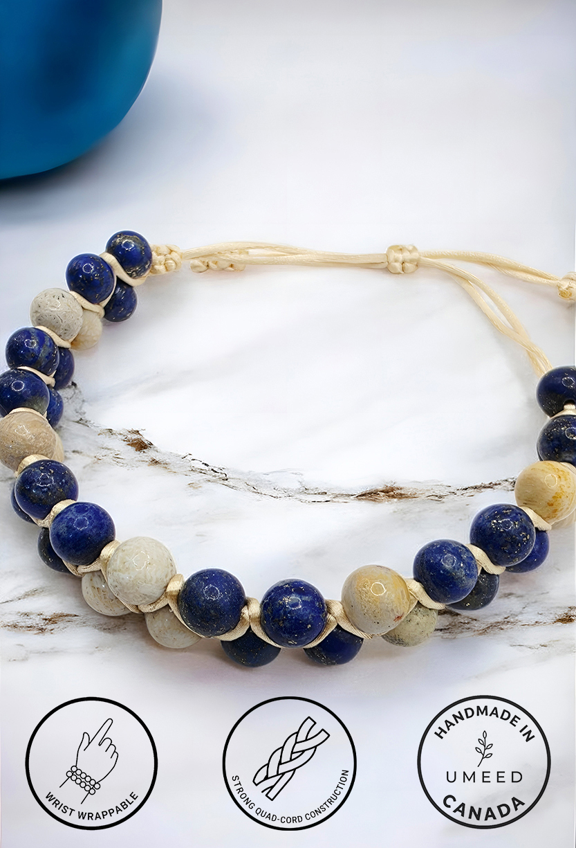 Handmade beaded necklace with blue and beige beads on white background.