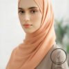 Elegant peach-colored hijab from Umeed Designs for modest fashion.