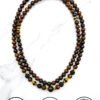 Handmade beaded necklace with wooden and gold accents from Umeed Designs.