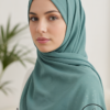 Elegant woman in teal hijab with subtle sparkle, Umeed Designs fashion.